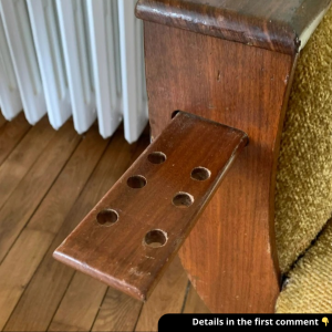 A sliding tray with holes on both sides of this sofa — what’s it for?