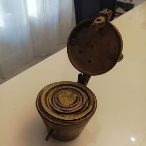 Discovered small brass cups that nest inside each other and lock shut. Any guesses on what they are